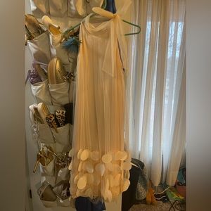 Boutique Beautiful cream dress with circle and frilly accents